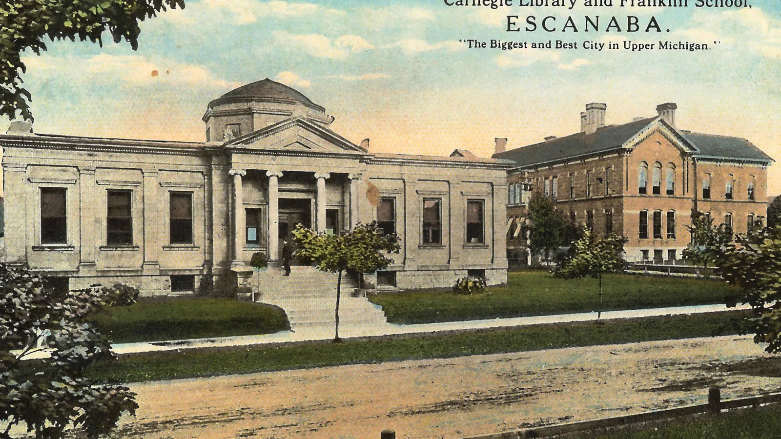 Historic postcard showing Carnegie Library and Franklin School in Escanaba